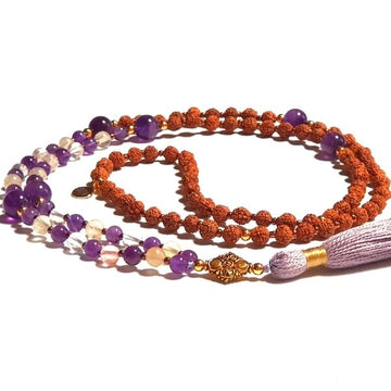 Handmade Reflection Mala Necklace – Amethyst & Tourmalinated Quartz for Balance curled on table
